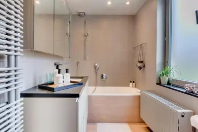 a bathroom with a bath tub and a sink at Koeketiene Rooms in Ghent