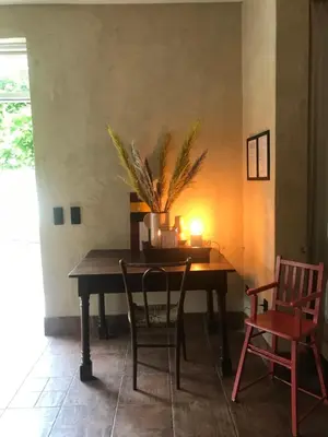 a dining room table with a candle and chairs at De Morgenstond in Baarle-Hertog