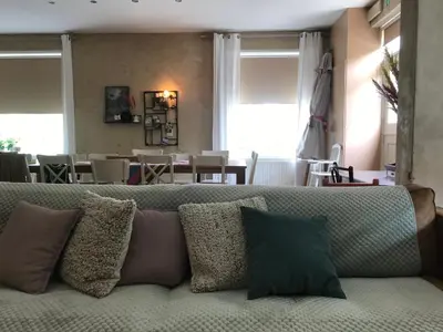 a couch with pillows sitting in a living room at De Morgenstond in Baarle-Hertog