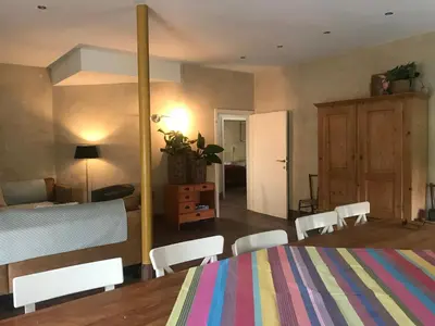 a bedroom with a bed and a table and chairs at De Morgenstond in Baarle-Hertog