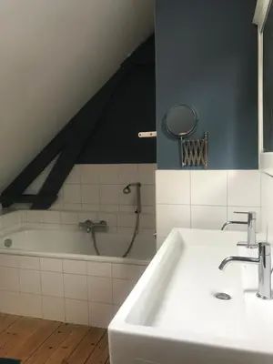 a bathroom with a sink and a bath tub at De Morgenstond in Baarle-Hertog