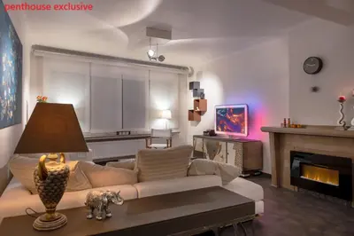 a living room with a couch and a fireplace at Antwerp Hideaway, outside of low emission zone in Antwerp