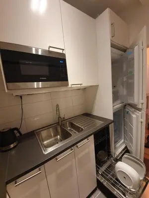 a small kitchen with a sink and a microwave at Antwerp Hideaway, outside of low emission zone in Antwerp