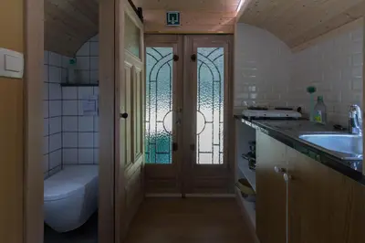 a bathroom with a toilet and a sink and a tub at Bij grenspaal 243 in Essen
