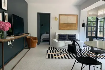 a living room with a couch and a table at Uccle, Pavillon Vert in Brussels