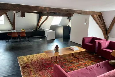 a living room with a couch and a table at GLORIA LOFT GENT in Ghent