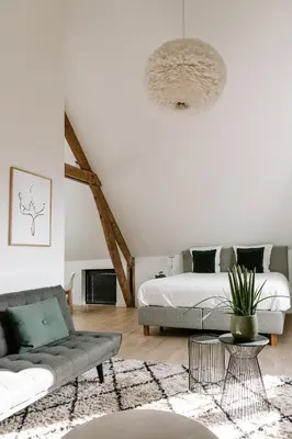 a living room with a bed and a couch at BnB Manere in Grimbergen