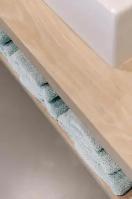 a close up of a wooden drawer with towels on it at BnB Manere in Grimbergen