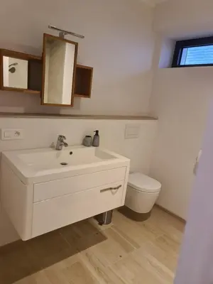 a white bathroom with a sink and a toilet at Villa Terlanen in Overijse