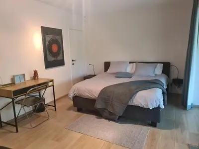 a bedroom with a bed and a table and a desk at Villa Terlanen in Overijse