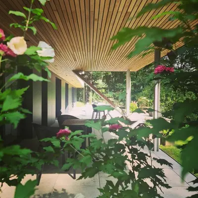 a patio with a table and chairs and flowers at Villa Terlanen in Overijse