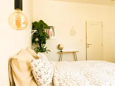 a bedroom with a bed and a potted plant at Appartement op top locatie in Antwerpen in Antwerp
