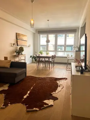a living room with a couch and a table at Appartement op top locatie in Antwerpen in Antwerp