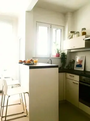 a kitchen with a counter and a chair in it at Appartement op top locatie in Antwerpen in Antwerp