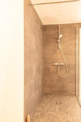 a shower with a shower head in a bathroom at Spacious modern appartments in the heart of Brussels in Brussels