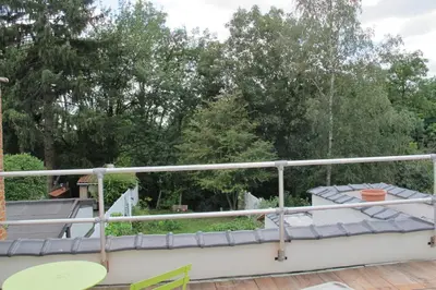 a balcony with a table and chairs and trees at Brussels Downtown with terrace in Brussels