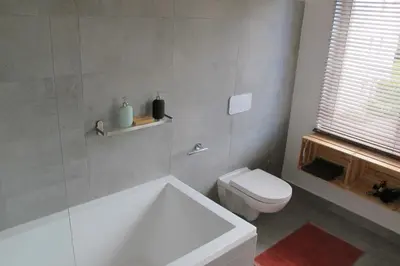 a bathroom with a white tub and a toilet at Brussels Downtown with terrace in Brussels