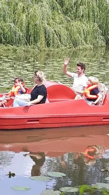 a group of people on a red boat in the water at Prachtige chalet Wabi Sabi aan het water! in Geel