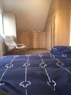 a bed with a blue blanket with drawings on it at Julie's Place in Westerlo