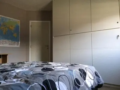 a room with a bed and a wall of cabinets at Julie's Place in Westerlo