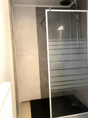 a shower with a glass door in a bathroom at Julie's Place in Westerlo