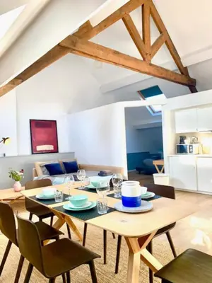 a living room with a wooden table and chairs at Cozy Apartment in Antwerpen Centraal in Antwerp