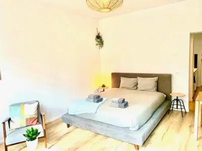 a bedroom with a bed and a chair at Cozy Apartment in Antwerpen Centraal in Antwerp