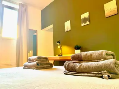 a room with a bed with towels on it at Cozy Apartment in Antwerpen Centraal in Antwerp