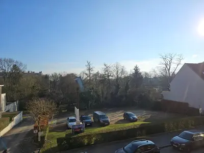 a group of cars parked in a parking lot at Modern duplex with garden in Brussels