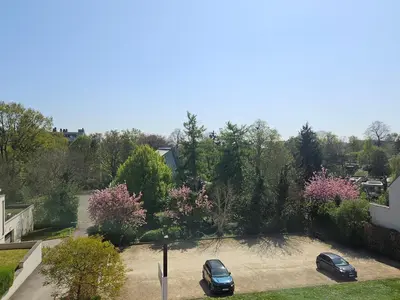 two cars parked in a parking lot in a yard at Modern duplex with garden in Brussels