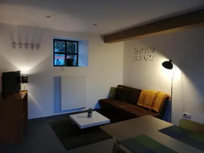 a living room with a couch and a table at Noest in Destelbergen