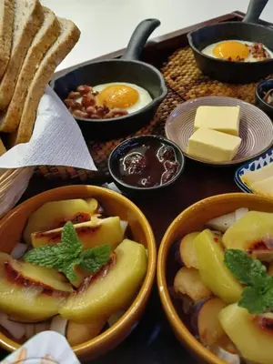 a table topped with bowls of food with eggs and bread at Noest in Destelbergen