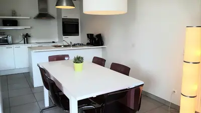 a kitchen with a white table and chairs at 19 Brussels Expo in Wemmel