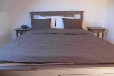 a bedroom with a large bed with two tables at 19 Brussels Expo in Wemmel