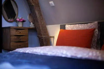 a bedroom with a bed and a mirror and a dresser at Luxury Suites Meir by Rikas Hotels in Antwerp