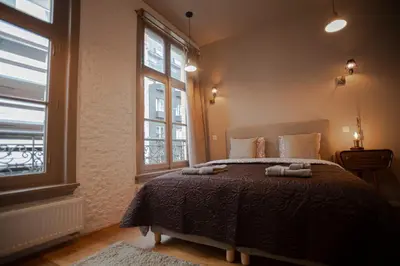 a bedroom with a bed with two towels on it at Luxury Suites Meir by Rikas Hotels in Antwerp
