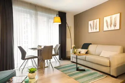 a living room with a couch and a table at Center Design Residence in Brussels