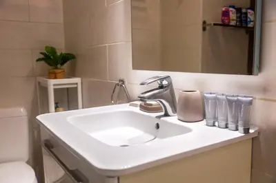 a bathroom with a white sink and a mirror at Center Design Residence in Brussels