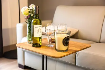 a bottle of wine and two glasses on a table at Center Design Residence in Brussels