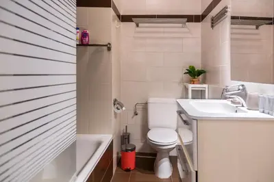 a bathroom with a toilet and a sink and a tub at Center Design Residence in Brussels