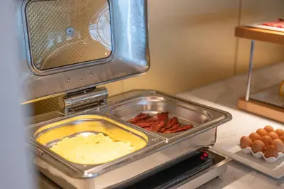 a kitchen counter with food in a toaster oven at B&B HOTEL Gent Centrum in Ghent