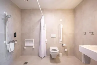 a bathroom with a shower and a toilet and a sink at B&B HOTEL Gent Centrum in Ghent