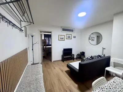 a living room with a black couch and a table at Сarnot Apartments ZOO Area in Antwerp