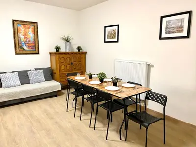 a living room with a table and chairs and a couch at Сarnot Apartments ZOO Area in Antwerp