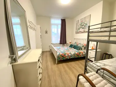 a bedroom with a bed and a bunk bed at Сarnot Apartments ZOO Area in Antwerp