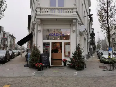 a store on a city street with christmas trees in front at The Penthouse, oasis of light and inspiration in Antwerp