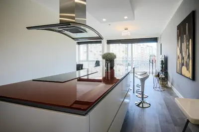 a kitchen with a counter top and a large window at Casa Plantin with parking place at the beautiful city park! in Antwerp