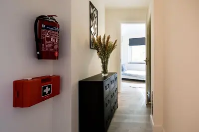 a room with a chest of drawers and a red box on the wall at Casa Plantin with parking place at the beautiful city park! in Antwerp