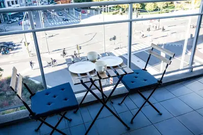 a table and chairs on a balcony with a view at Casa Plantin with parking place at the beautiful city park! in Antwerp