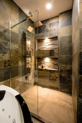 a bathroom with a tub and a glass shower at Casa Plantin with parking place at the beautiful city park! in Antwerp